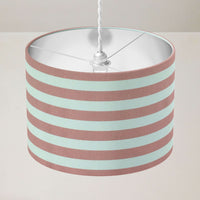 Country cottage striped lampshade with pink and white stripes on a plain background.