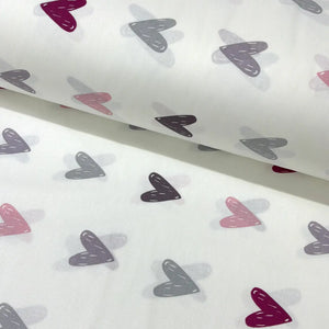 Cotton heart fabric patterned with blush pink, grey, charoal and burgundy hearts on a white background.
