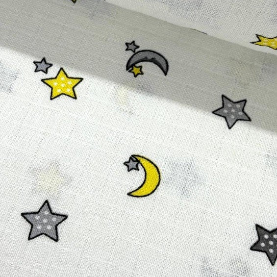 100% cotton muslin double gauze fabric featuring yellow grey moon and stars celestial pattern on a white background.