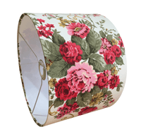 Drum lampshade designed with pink and red flowers  and green leaves on a white background.