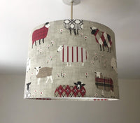 Lampshade with sheep pattern hanging on a ceiling.