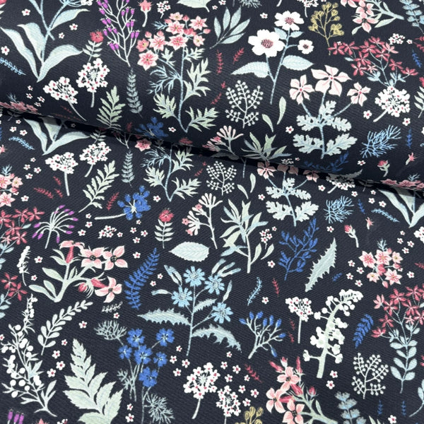 Dark floral patterned upholstery fabric with colorful flowers on a black background.