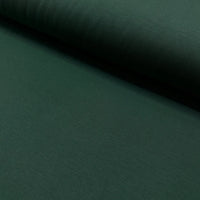 Dark forest green cotton canvas fabric with a plain woven texture, suitable for upholstery, curtains, cushions, bags, crafts, and soft furnishing projects.