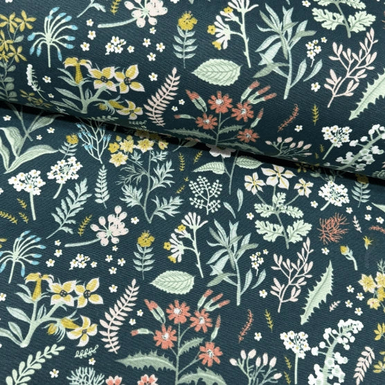 Yellow and coral red wild flowers and sage green leaves patterned forest green tapestry upholstery curtain fabric.