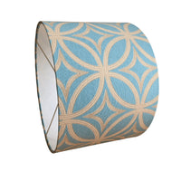 Decorative drum lampshade with duck egg blue and gold geometric pattern on a white background.