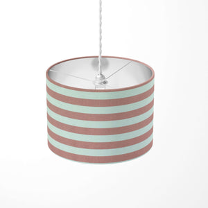 Striped ceiling pendant lampshade with pink and white stripes on a white background.
