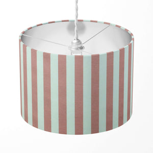 A dusty pink vertical striped lampshade suitable for bedroom, living room or kitchen lighting.