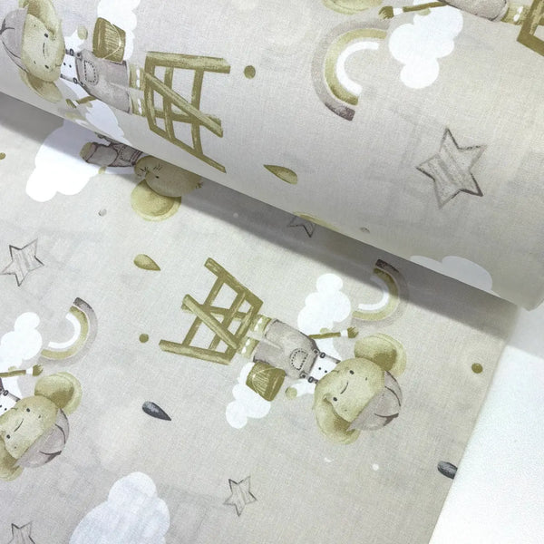 Beige elephant nursery 100% cotton poplin fabric featuring cute elephants, rainbows, clouds and stars for baby quilts, children's clothing and nursery décor.
