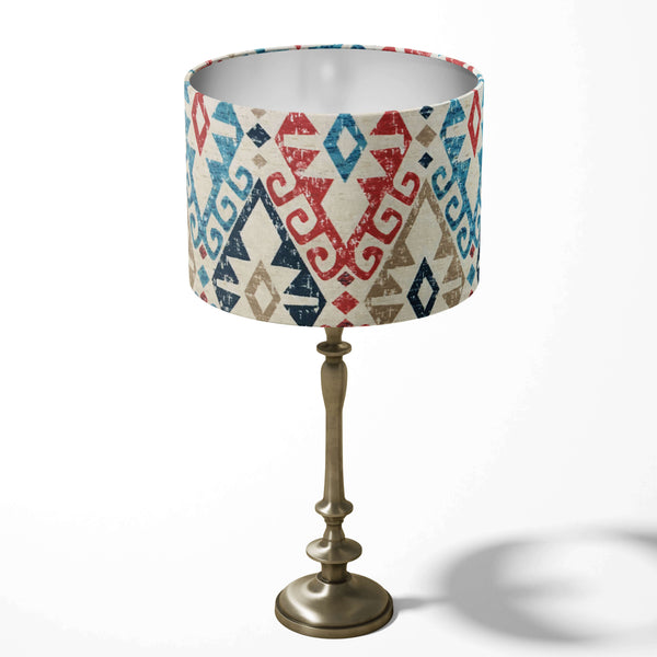 Kilim patterned ethnic table lampshade in red, navy blue and beige on a white background.
