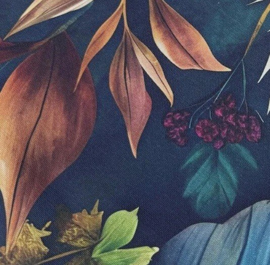 Close-up of earthy exotic leaves print fabric.