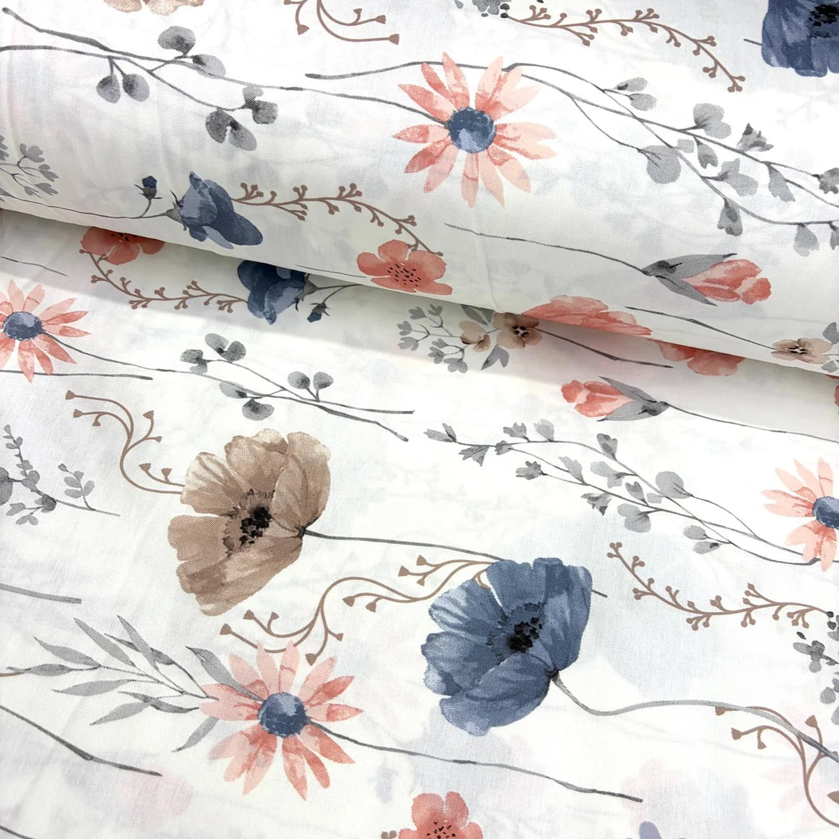 Floral painting cotton poplin fabric with blue and blush pink flowers, taupe blooms and grey botanical foliage on a white background.