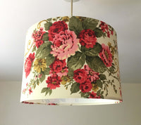 Red green floral patterned country cottage ceiling lampshade on a plain background.