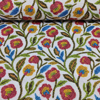 Multicolour folk flower upholstery curtain fabric in a vine print style.