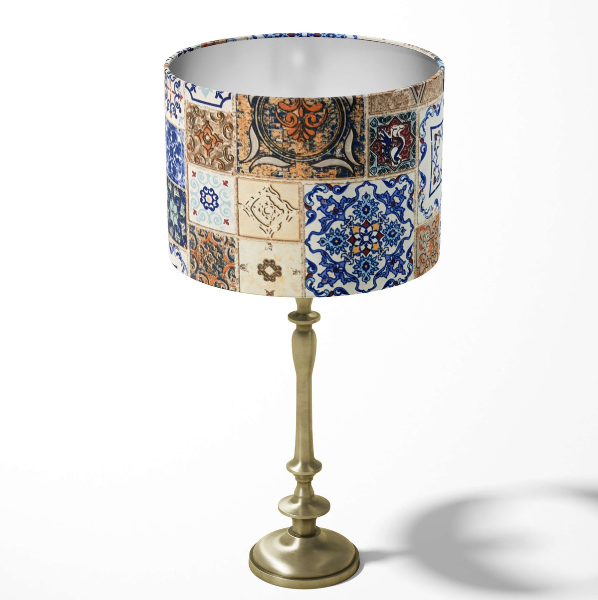 Geometric spanish tile patterned table and floor lampshade in blue, beige and brown.