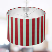 Striped lampshade with red and white vertical stripes on a blurred background.