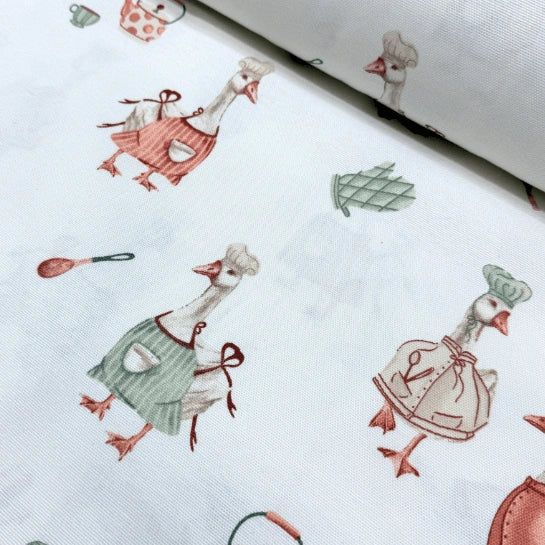 Coral red and sage green duck print cotton canvas upholstery curtain fabric on white background.