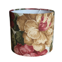 Close up of light brown and brick red floral print lampshade.