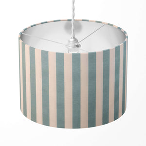 A mint green and white striped drum lampshade on a white background.