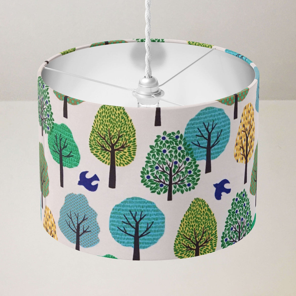 Lampshade with jungle forest pattern on a plain background.