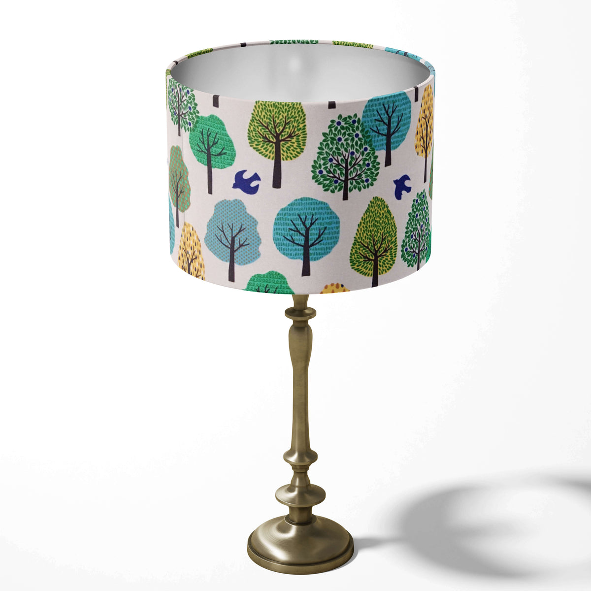 Green woodland table lampshade with trees and birds pattern.