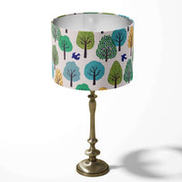 Green woodland table lampshade with trees and birds pattern.
