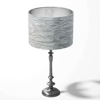 Grey table drum lampshade with a coastal surf pattern on a white background.