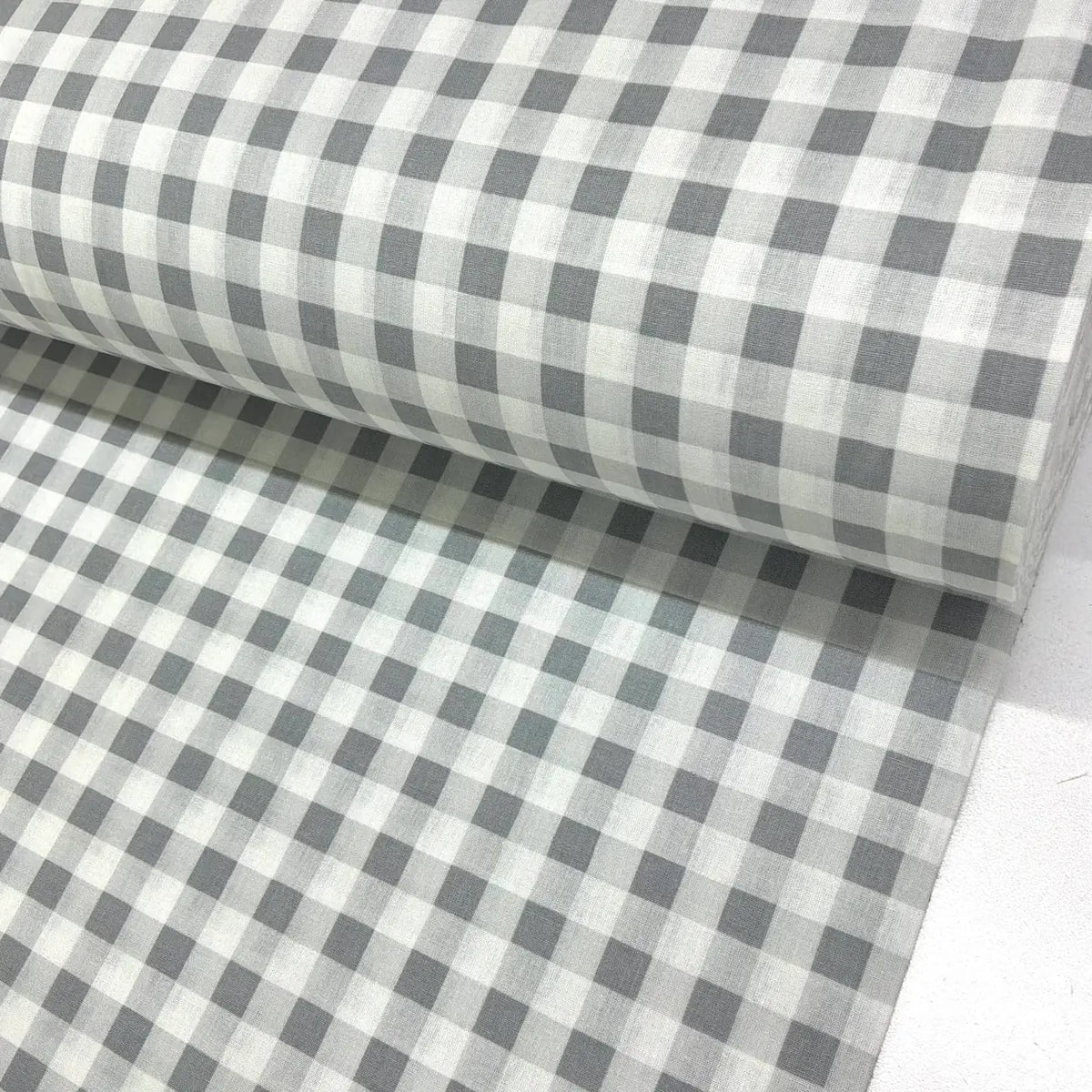Grey and white gingham check 100% cotton fabric with a classic checkered pattern, ideal for dressmaking, quilting, patchwork, crafts and home décor.