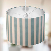 Light green and white striped lampshade with a blurred background.