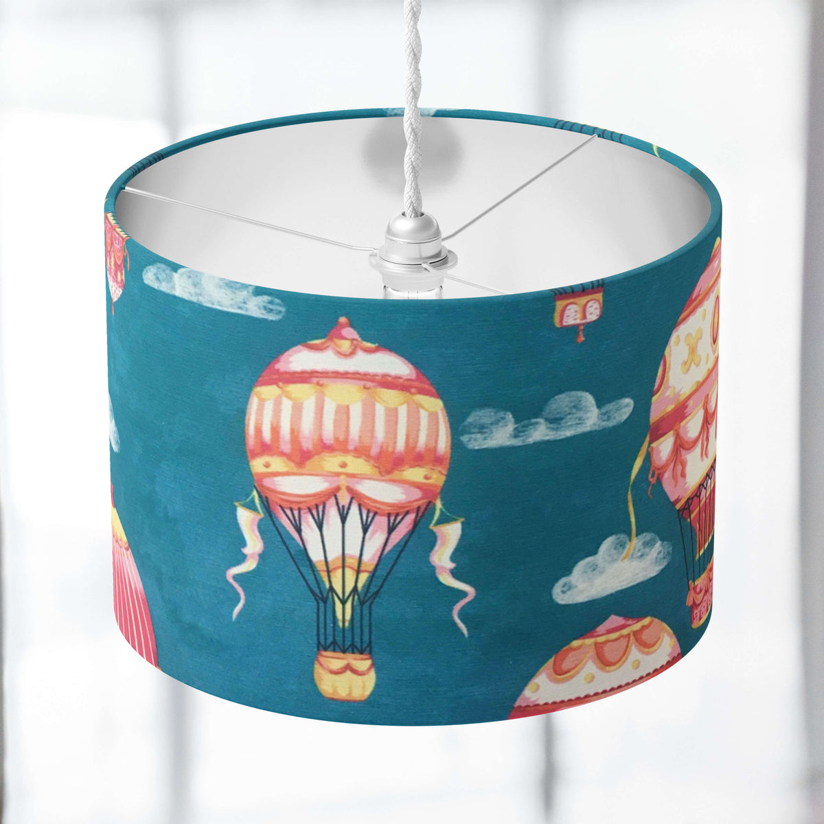 Kids nursery lampshade with hot air balloon design on a blurred background.