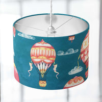 Kids nursery lampshade with hot air balloon design on a blurred background.