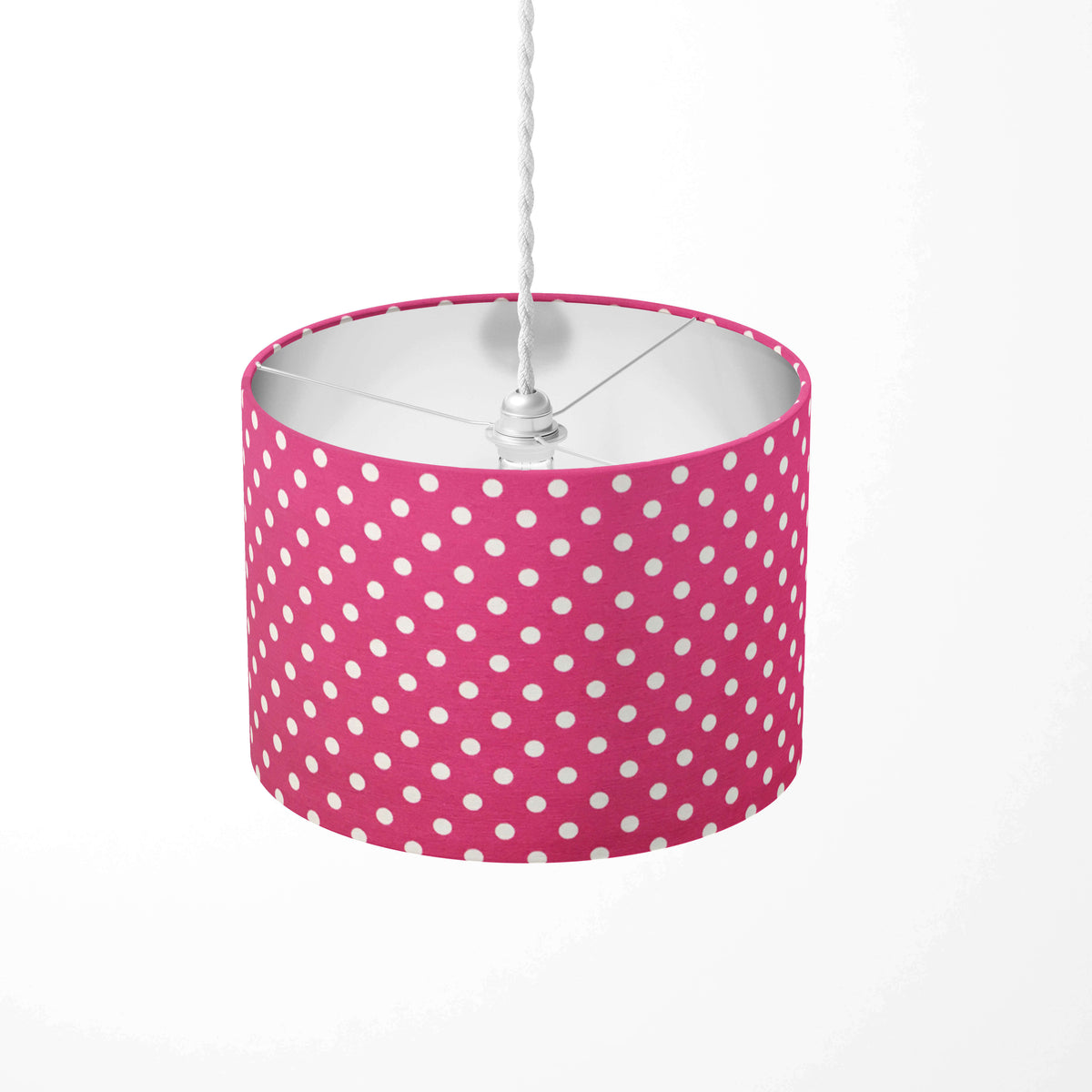 Fuchsia ceiling lampshade with white polka dots on a white background.