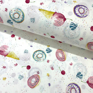 Patterned cotton poplin fabric with colorful donuts, ice cream cones, and cherries on a white background.