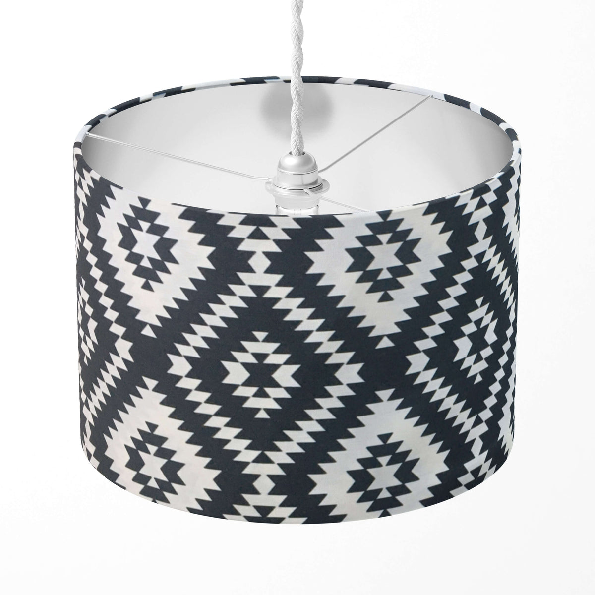 Ikat lampshade with black and white geometric pattern on a white background.