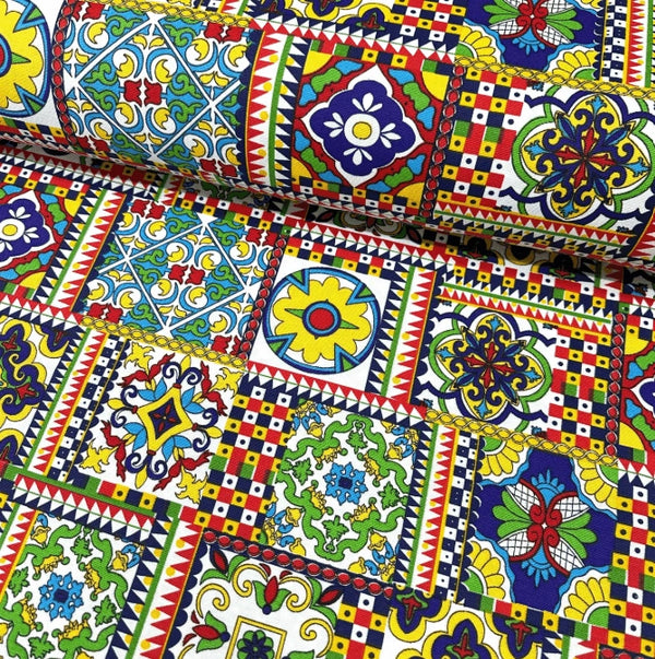 Colorful patterned upholstery fabric with geometric tile and floral designs.