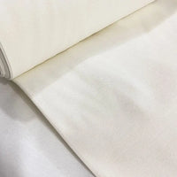 Ivory off white cotton canvas upholstery fabric with a plain woven texture, ideal for curtains, cushions, chairs, sofas, furniture and sewing projects.