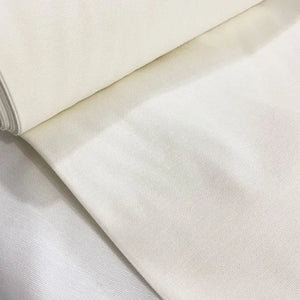 Ivory off white cotton canvas upholstery fabric with a plain woven texture, ideal for curtains, cushions, chairs, sofas, furniture and sewing projects.