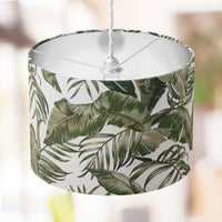 Green and white lampshade with an exotic leaf pattern on a white background.