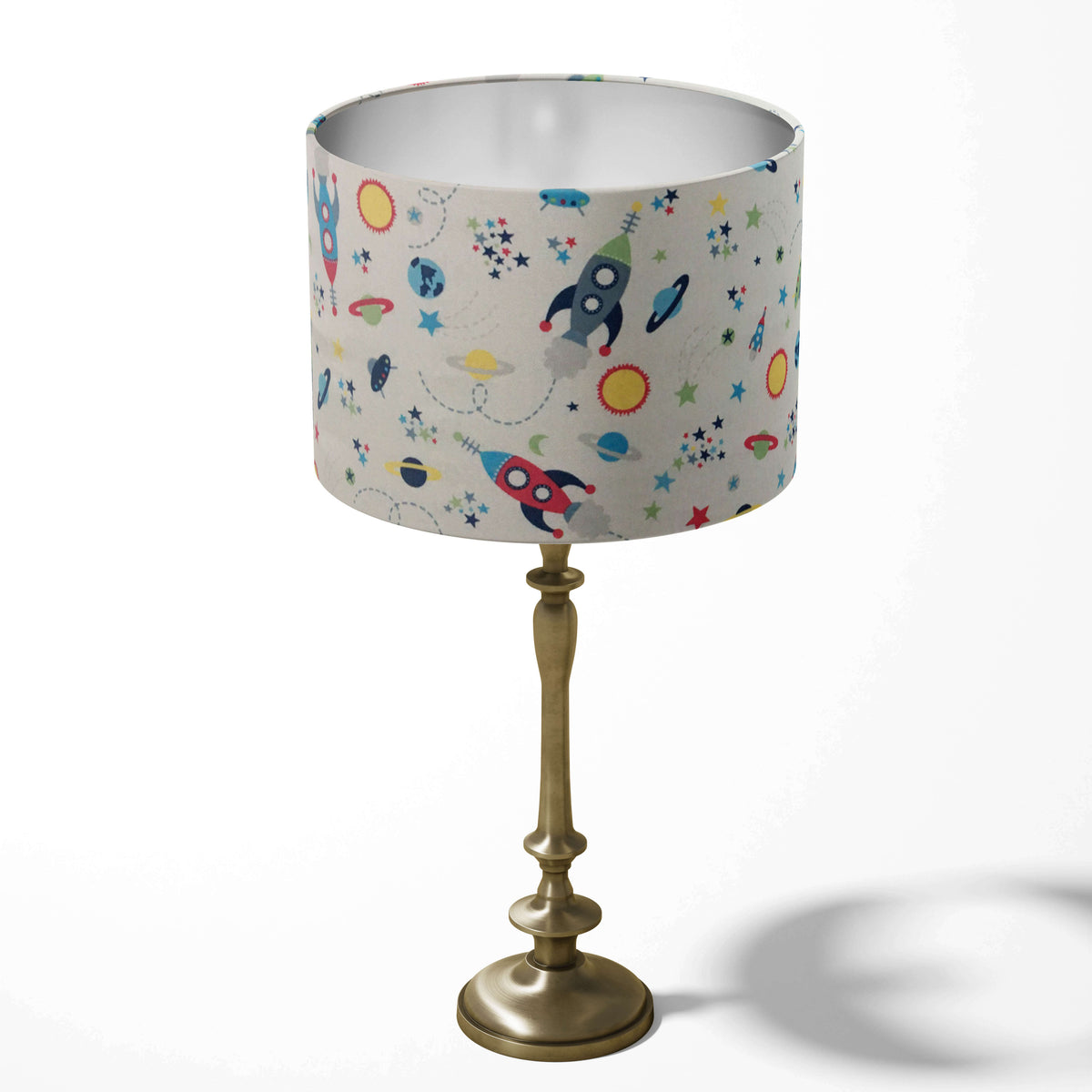 Boys room lampshade with planets, rockets, sun and stars pattern on a white background.