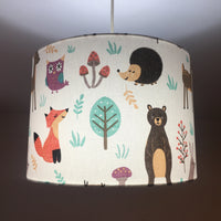 Woodland animal print ceiling lampshade featuring fox, rabbit, reindeer, bear, owl, tree and mushroom patterns.