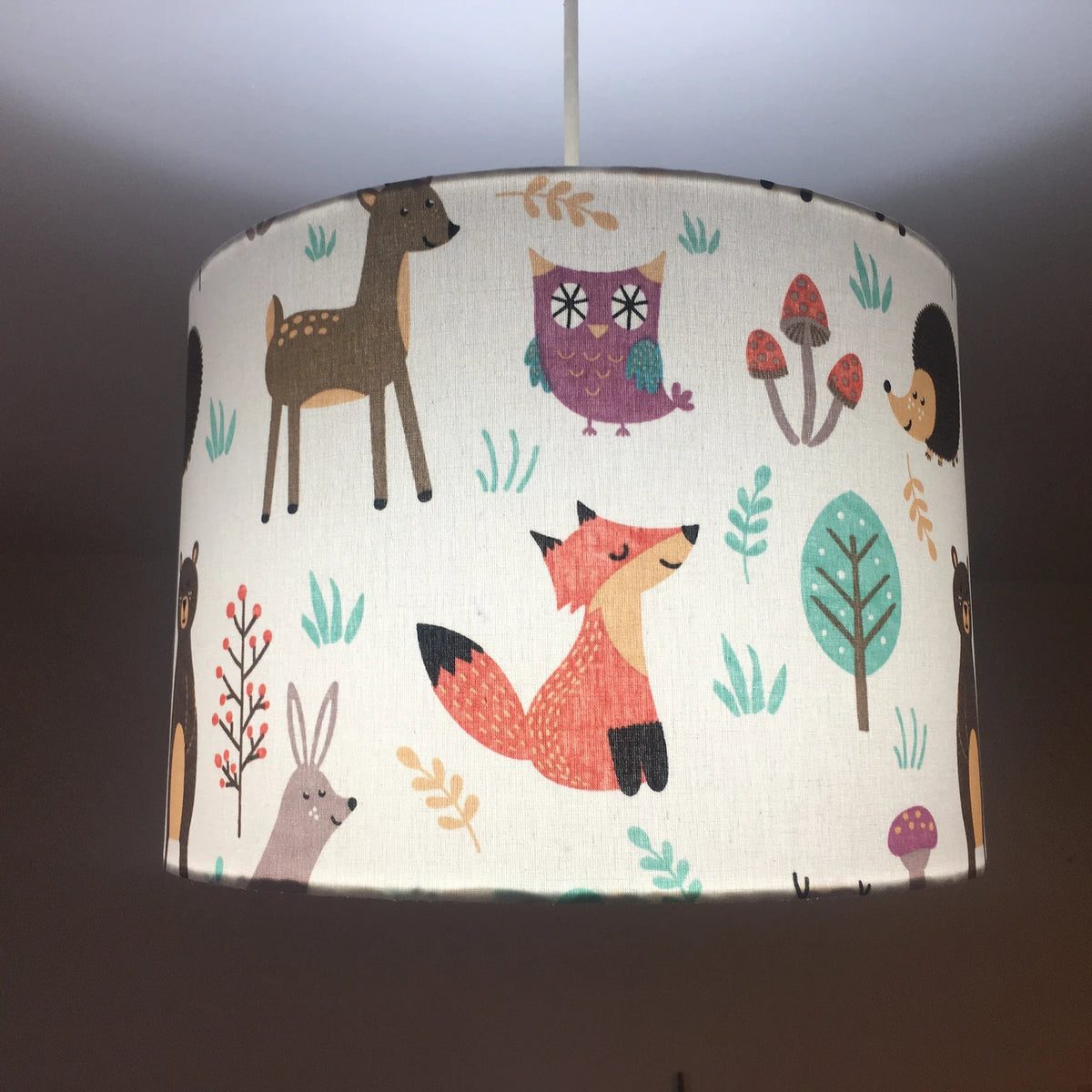 Woodland animal ceiling light shade featuring fox, rabbit, reindeer, bear, owl, tree and mushroom patterns.