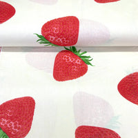 Large strawberry print cotton fabric on a white background with realistic red strawberries, ideal for dressmaking, quilting, crafts and home decor.