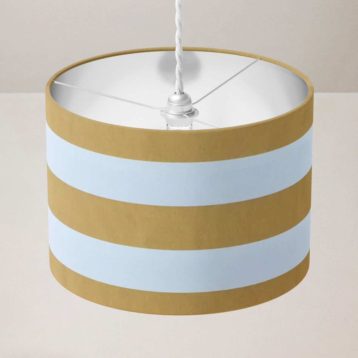 Mustard yellow large striped ceiling pendant  lampshade on a plain background.