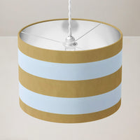 Mustard yellow large striped ceiling pendant  lampshade on a plain background.