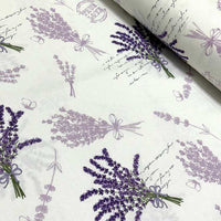 Lavender floral upholstery fabric patterned with purple lilac flowers on a white background.