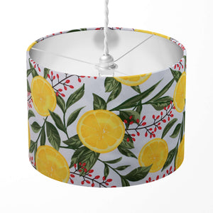 Lampshade with yellow lemon and green leaf pattern on a white background.