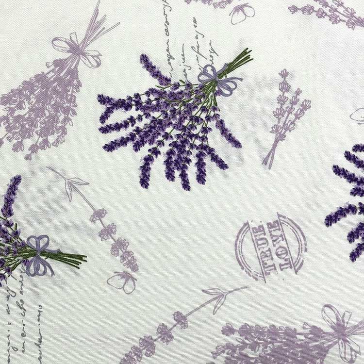 Cotton canvas upholstery fabric patterned with lavender flowers in lilac and purple on a white background.