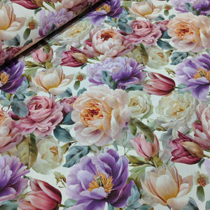 Upholstery fabric patterned with 3d pink, lilac, and cream flowers on a light background.