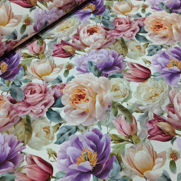 Upholstery fabric patterned with 3d pink, lilac, and cream flowers on a light background.