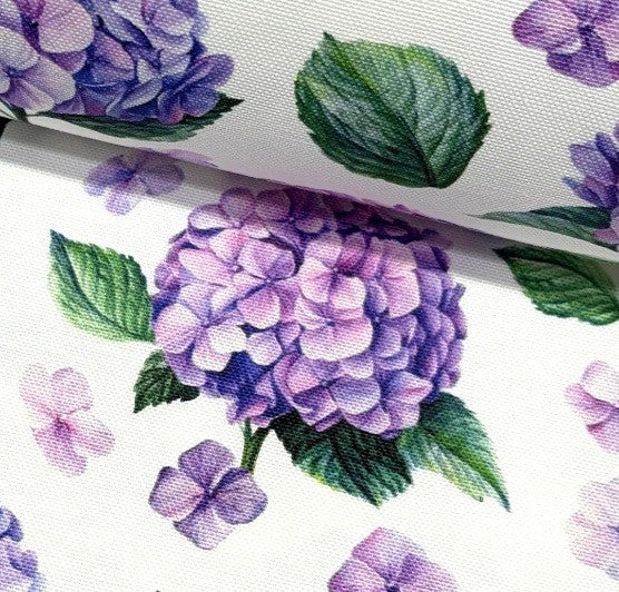 Close-up of purple hydrangea flowers and green leaves on a white background.