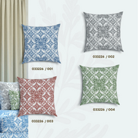 Set of tile patterned cushions in blue, grey, red and green on a white background.